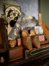 Load image into Gallery viewer, Vintage wooden shoes on a rustic shelf with decorative items

